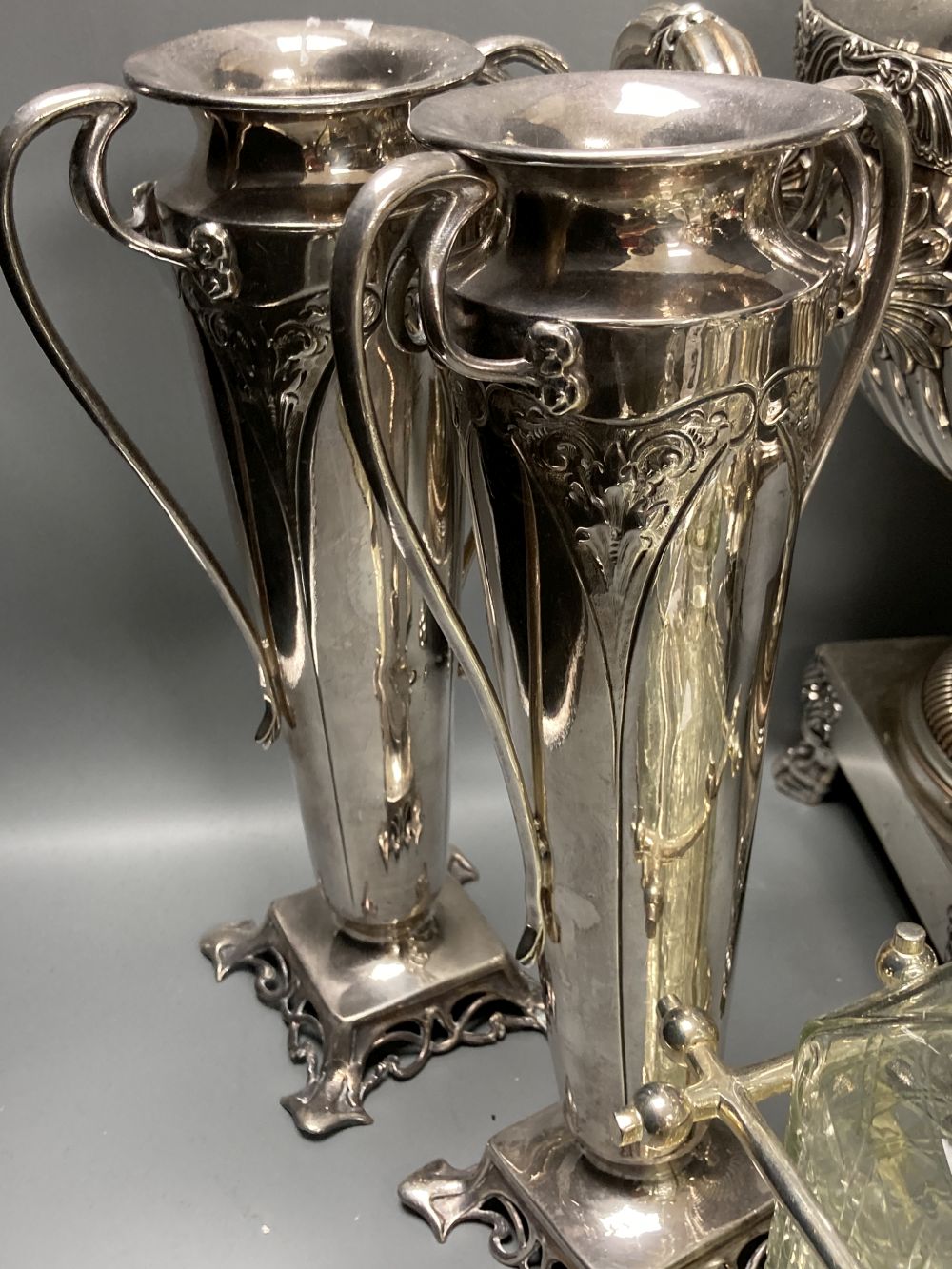 A plated samovar, a kettle on stand, a pair of vases and a three bottle silver plated tantalus and on Old Sheffield plate tea urn, c.18